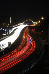 Illuminated light trails on road at night