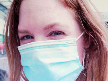 Close-up portrait of a woman covering face