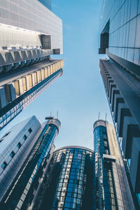 Low angle view of modern buildings against clear blue sky