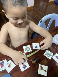 High angle view of cute boy holding table