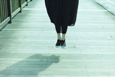 Low section of woman standing on tiled floor