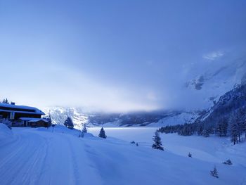 Scenic view of snow covered landscape against sky