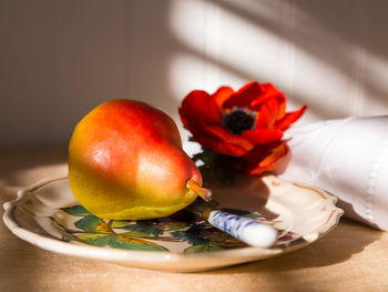 Selective focus still life with beautiful bartlett pear in hand-painted plate