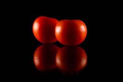 Close-up of tomatoes against black background