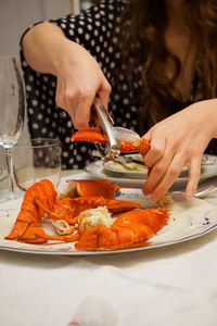 Close-up of woman preparing food in plate