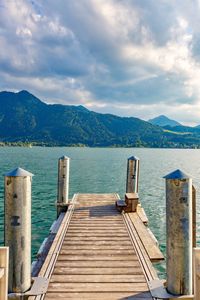 Wooden pier over lake against sky