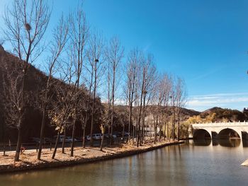 Arch bridge over river against sky