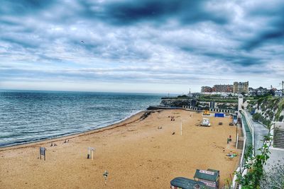 View of beach against cloudy sky