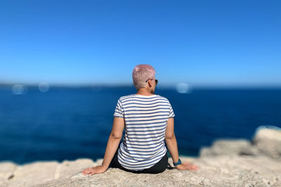 Full length of man on beach against clear sky