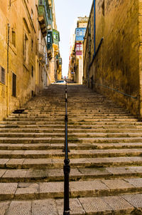 Footpath amidst buildings in city