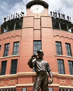 Low angle view of statue against building in city