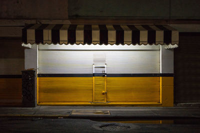 Closed shutter of store at night