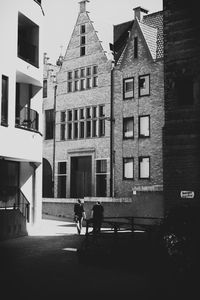 People walking in front of residential buildings