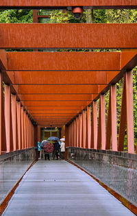 Rear view of woman walking on footpath