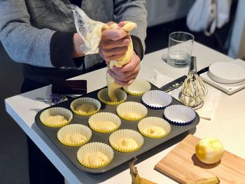Midsection of person preparing food on table