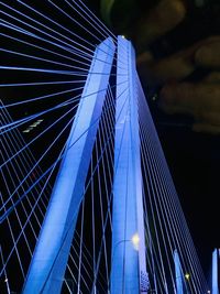 Low angle view of suspension bridge against sky