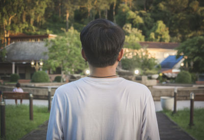 Rear view of man standing in yard