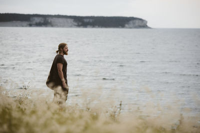 Side view of man standing on beach