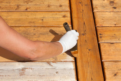 Midsection of man sitting on wooden floor