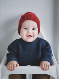 Portrait of cute baby boy sitting in hat