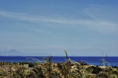 Scenic view of sea against blue sky