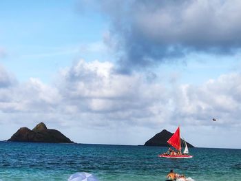 Sailboat on sea against sky