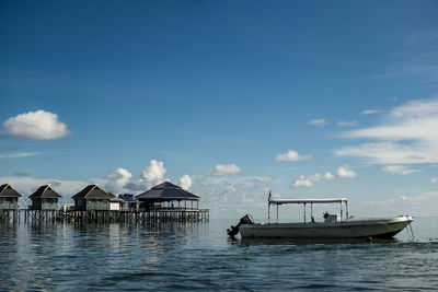 Fishing boat in sea against sky