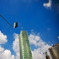 Low angle view of skyscraper against blue sky