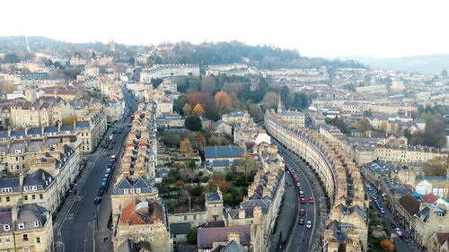 High angle view of vehicles on road amidst buildings in city