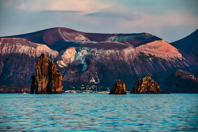 Panoramic view of rocks in sea against sky