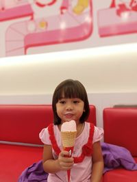 Portrait of young woman holding ice cream