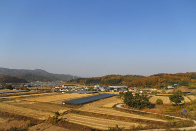 High angle view of agricultural field against clear blue sky