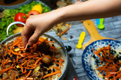 Cropped hand of person preparing food