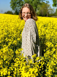 Laughing woman standing in field