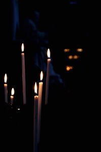 Close-up of illuminated candles in temple