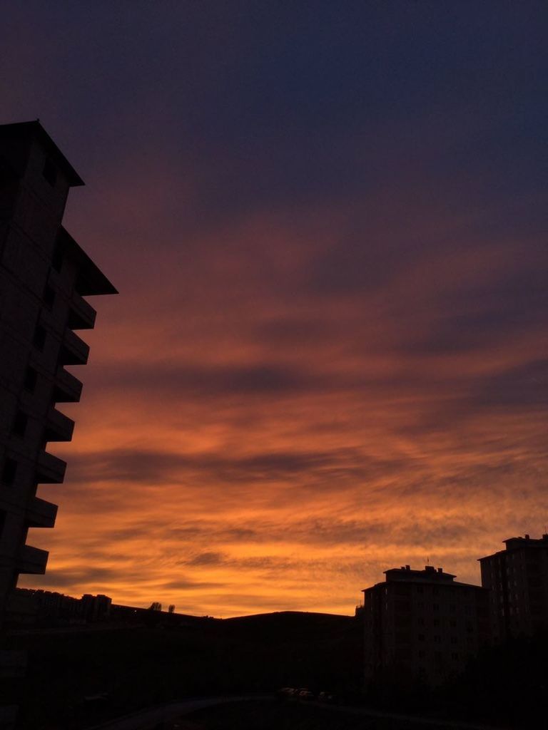 LOW ANGLE VIEW OF SILHOUETTE BUILDINGS AGAINST ORANGE SKY