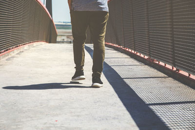 Low section of man standing on footpath