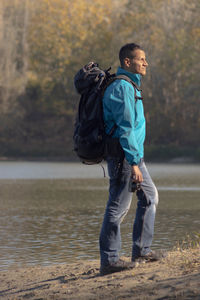 Portrait of traveler man at lake in autumn
