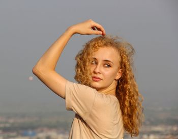 Portrait of woman standing in water against sky