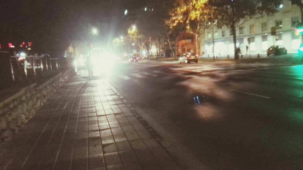 night, illuminated, street, wet, road, built structure, outdoors, real people, architecture