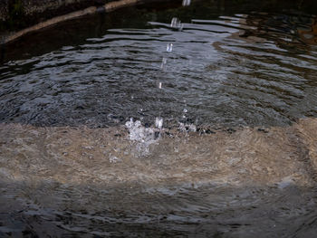 High angle view of water flowing over lake