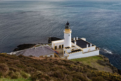 High angle view of lighthouse by sea