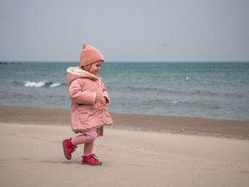 Portrait of woman standing at beach