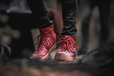 Low section of man standing on field