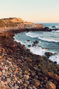 Rocks on beach against sky