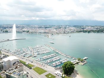 High angle view of city by sea against sky