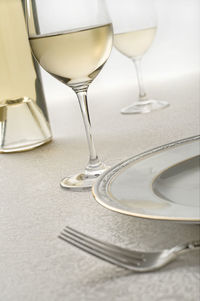 Close-up of wine glasses on table