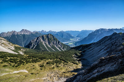 Scenic view of mountains against clear blue sky