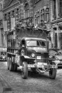 Vintage car on road by buildings in city