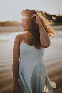 Young woman standing at beach